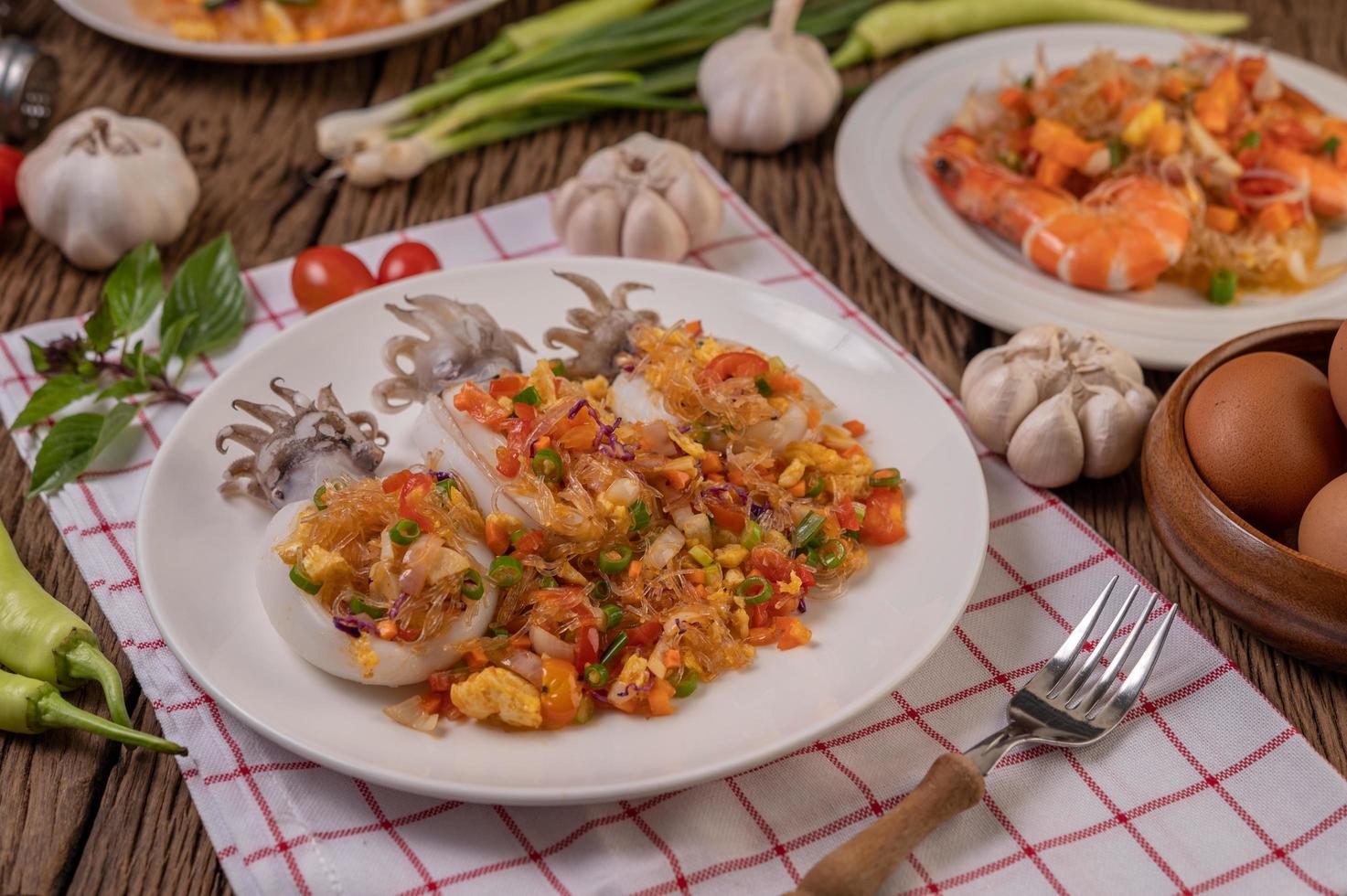 Stir fried glass noodles with squid on a red and white cloth photo