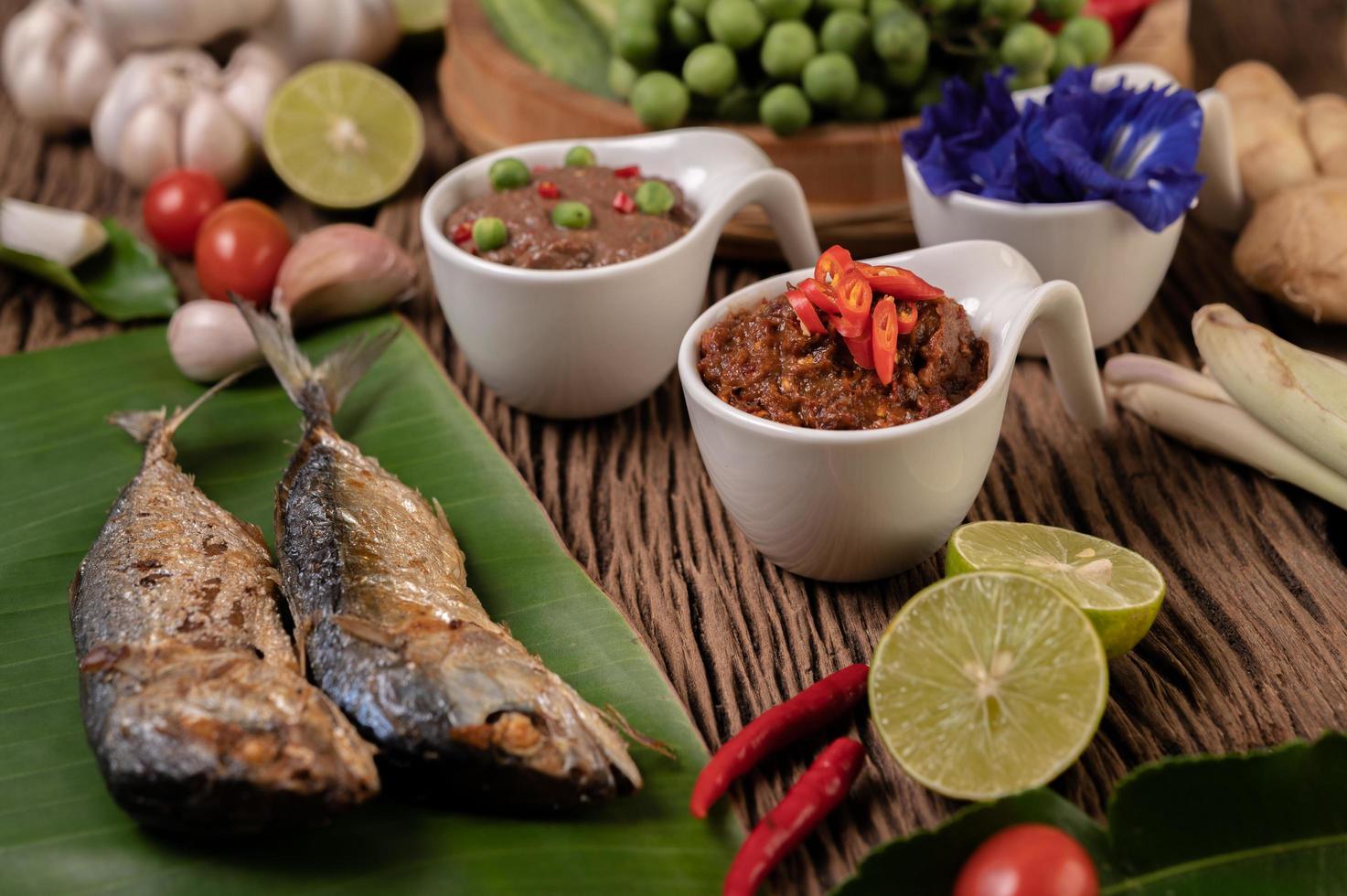 Shrimp paste and mackerel, fried on banana leaves with chili, tomato and garlic photo