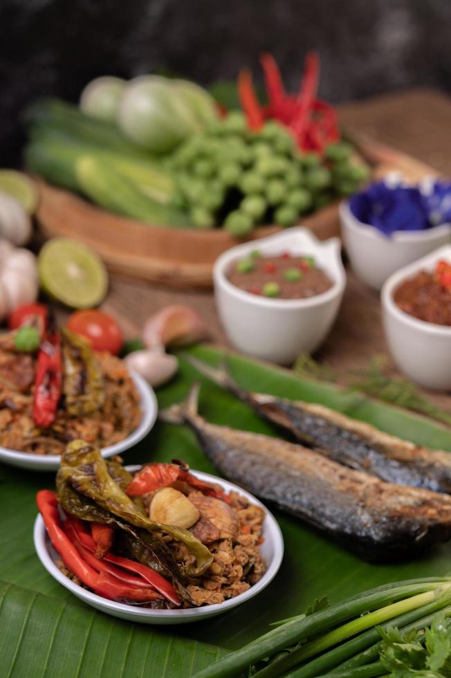 Shrimp paste and mackerel, fried on banana leaves with chili, tomato and garlic photo