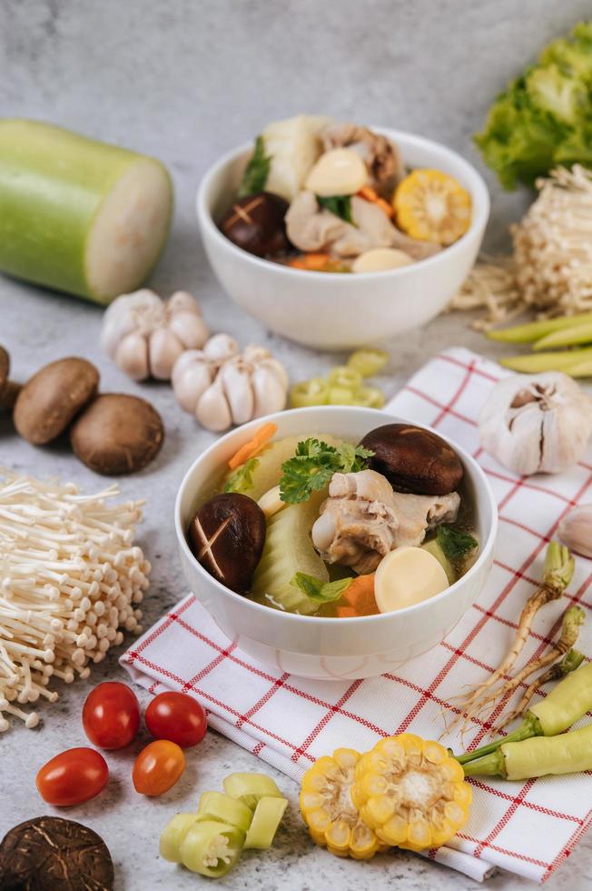 Chicken soup with corn, shiitake mushroom, enoki mushroom and carrot photo