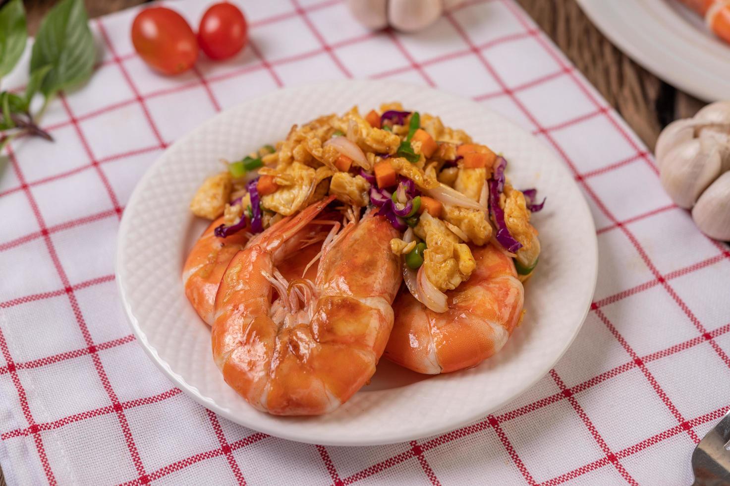 Fried shrimp with eggs on a red and white cloth photo