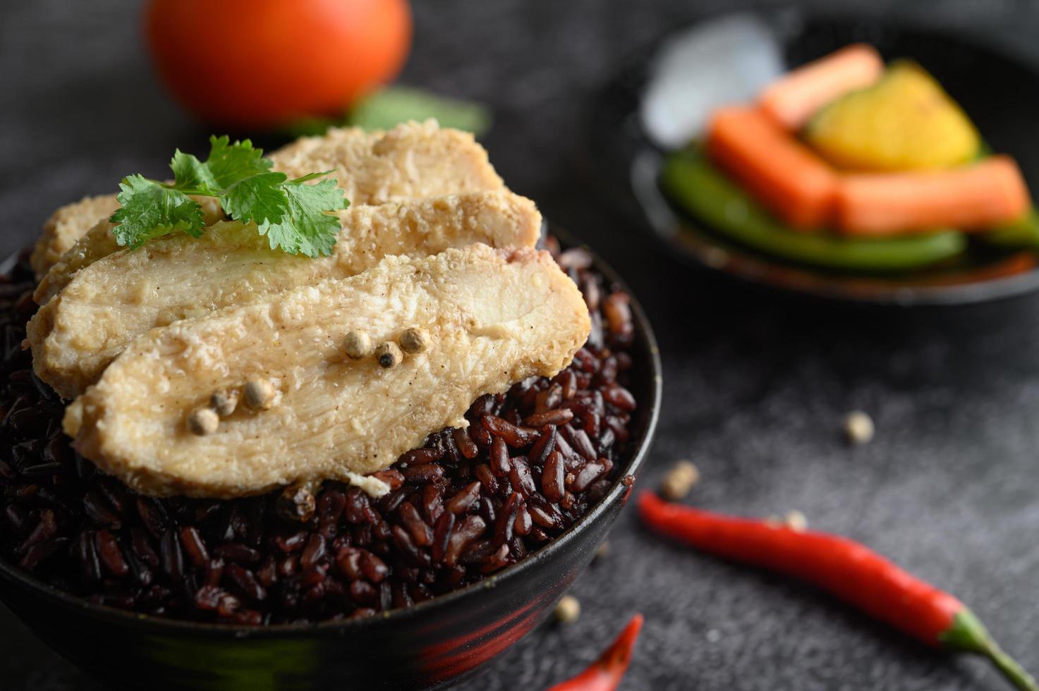 Grilled chicken breast with peppers on ripe purple rice berries photo