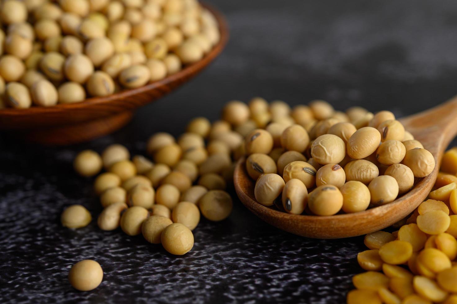 Yellow beans in a wooden bowl on black background photo