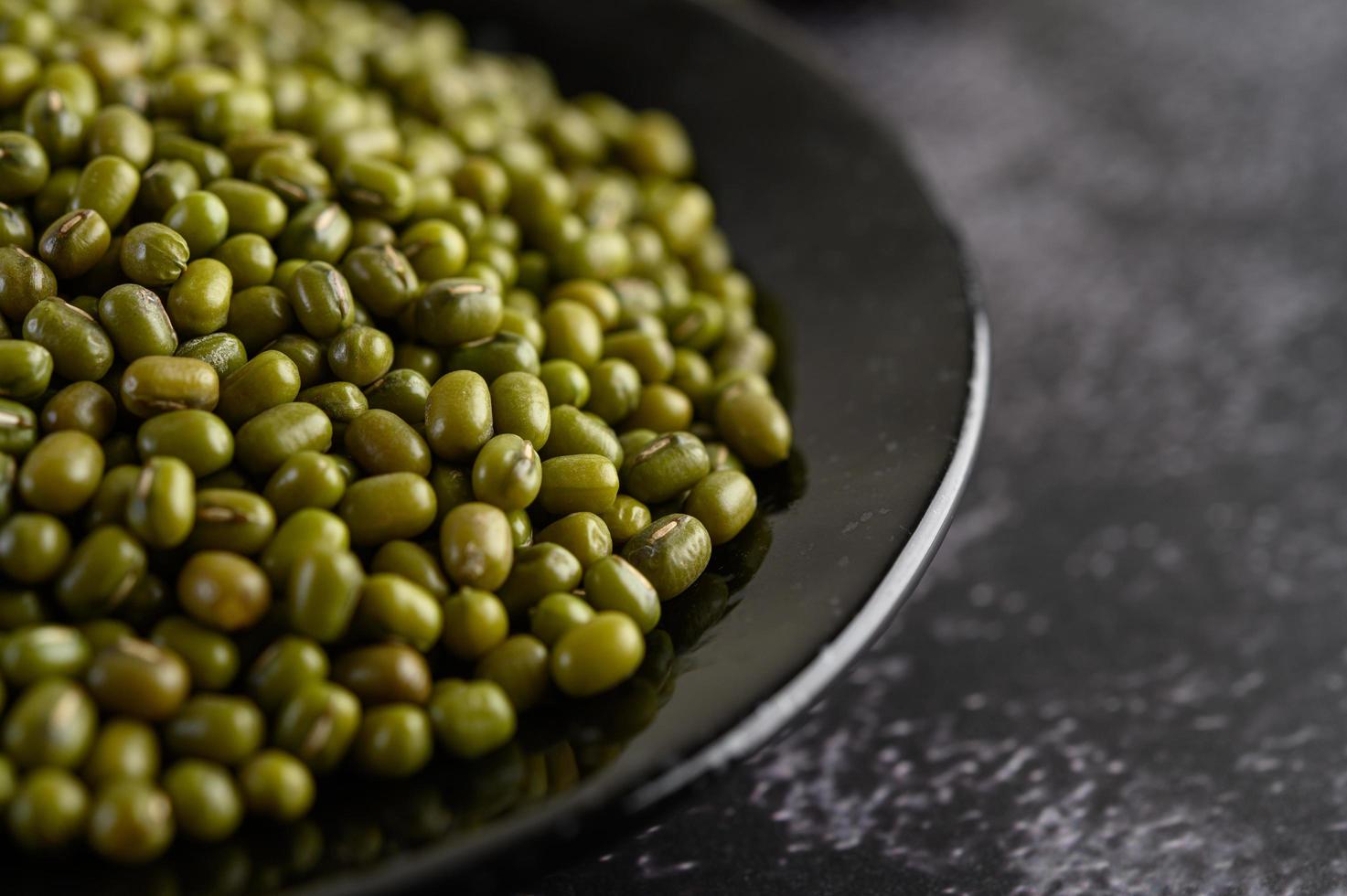 Mung beans on a plate on black cement photo