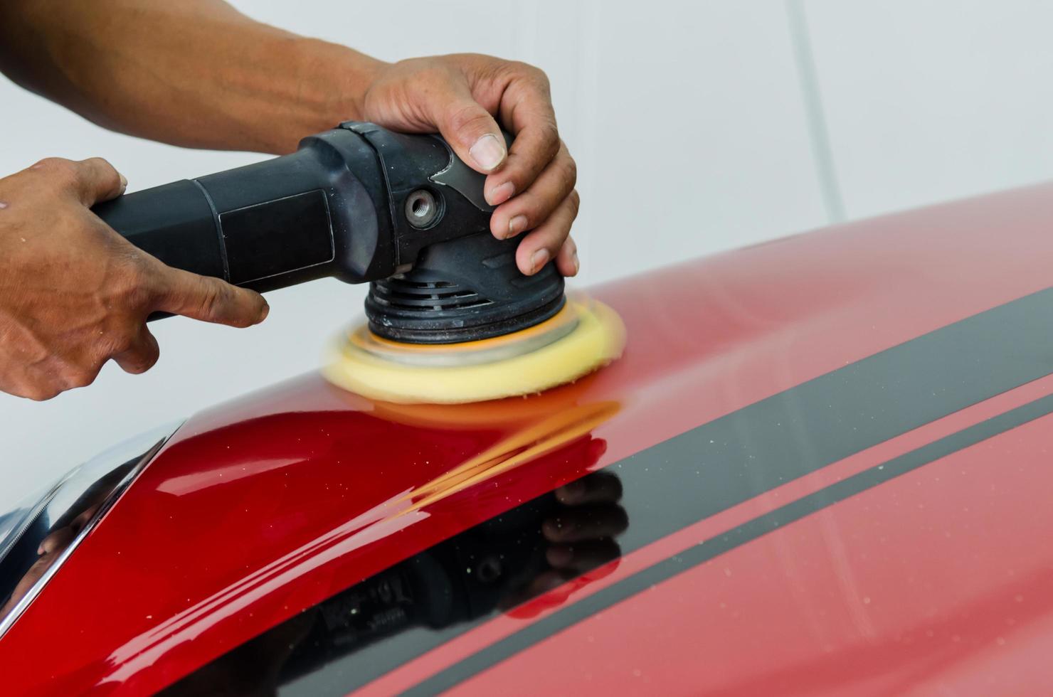 Polishing a red car photo