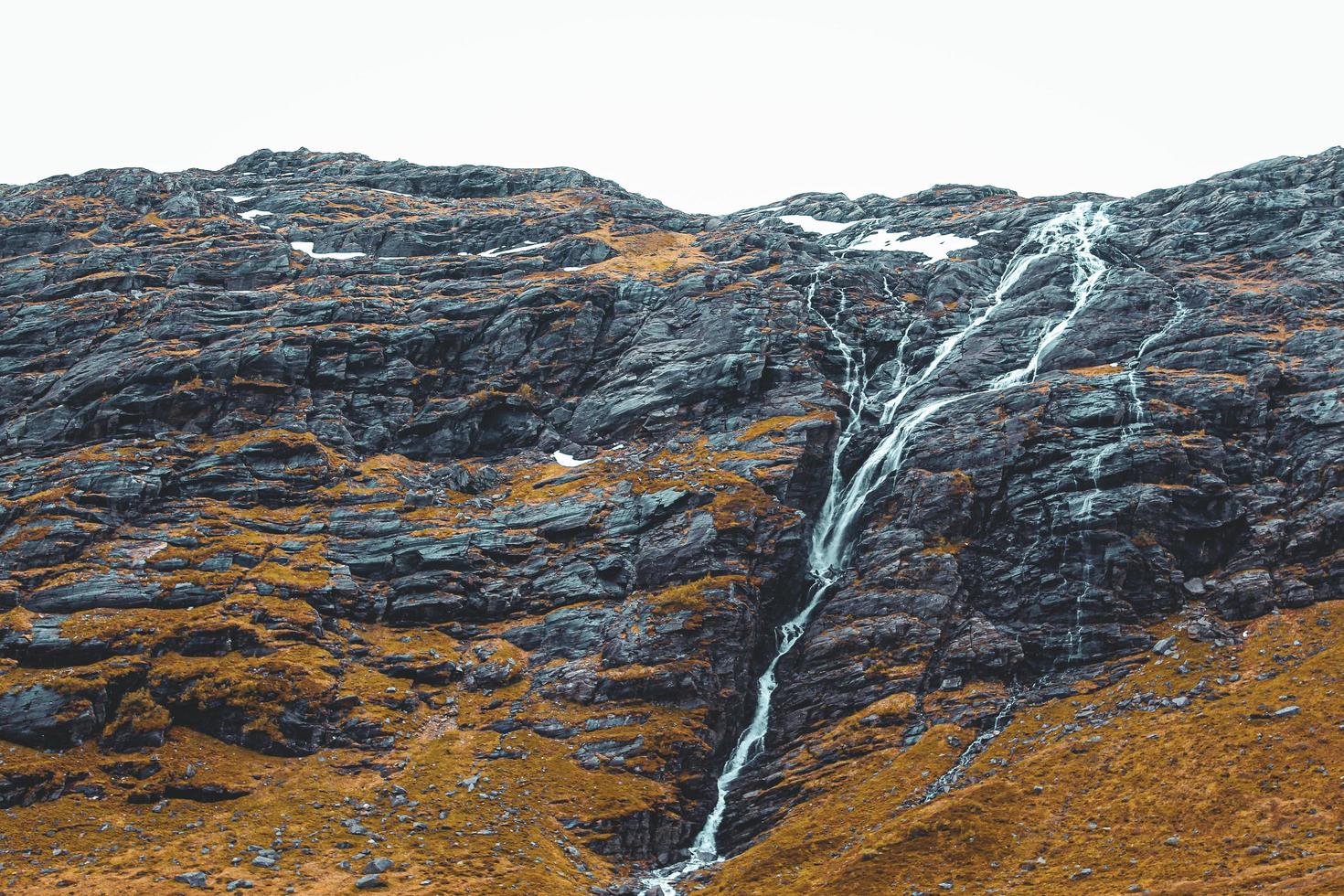 Waterfall in a black rock mountain photo