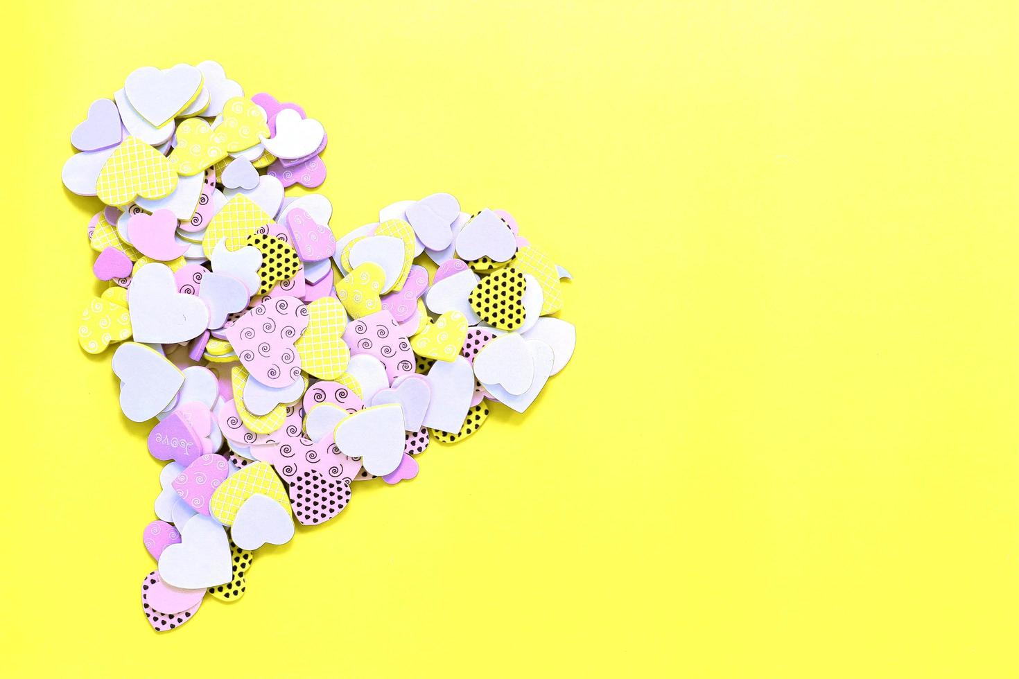 Confetti hearts on yellow photo