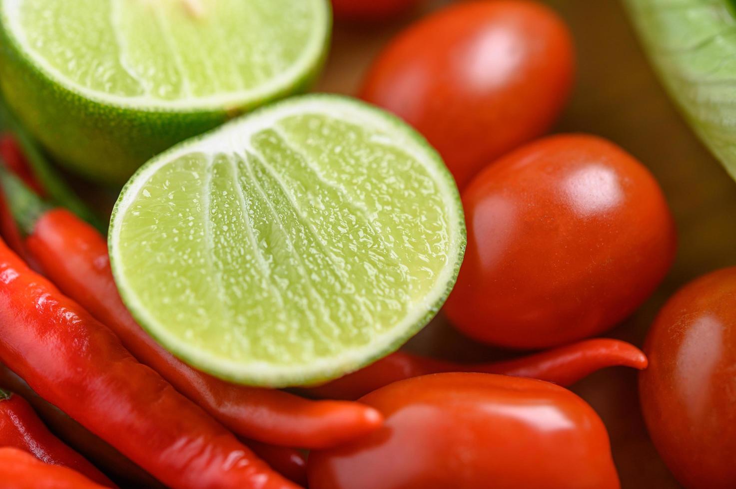 Bright close-up of lime, garlic, tomato and peppers photo