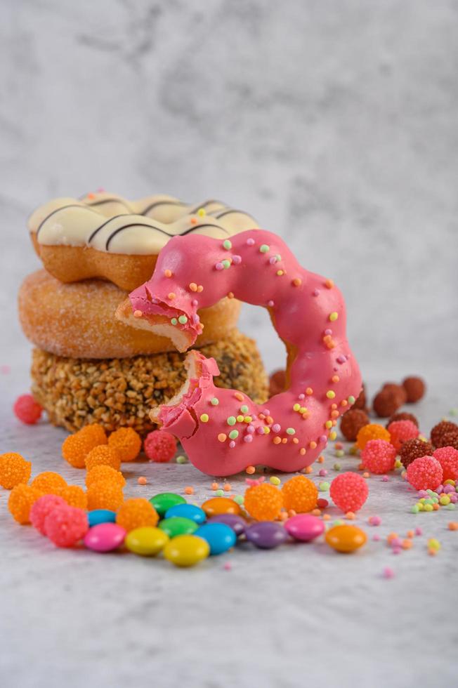 Assorted stack of donuts on neutral background photo