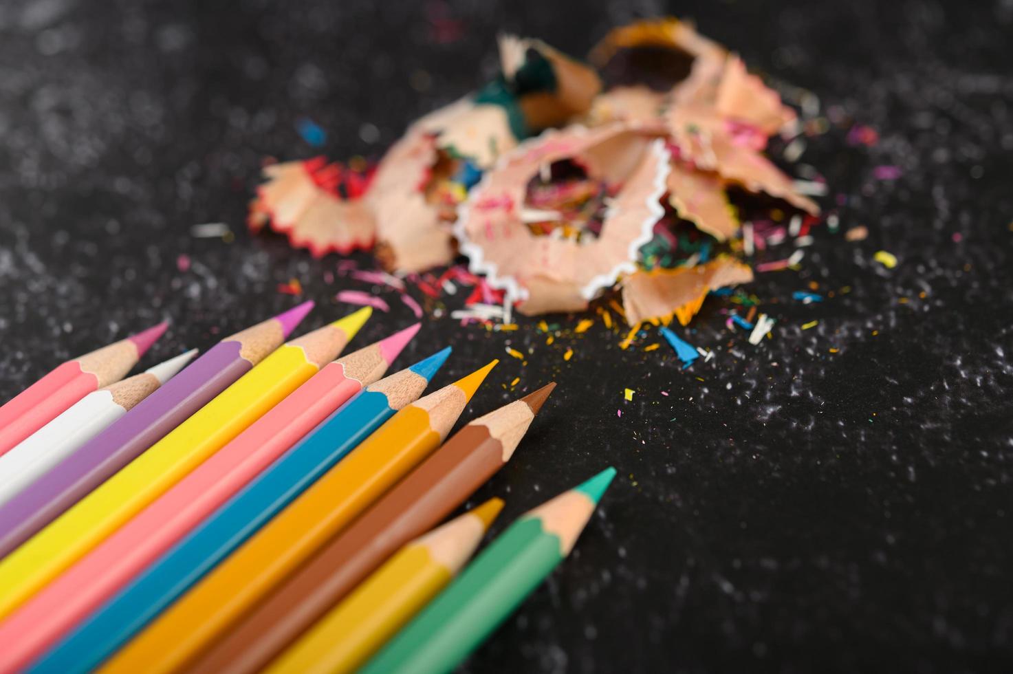 Close-up of color pencils and shavings, flat lay photo