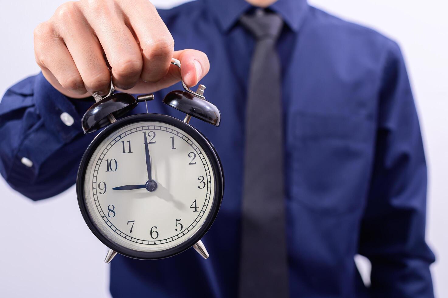 Man holding a clock photo