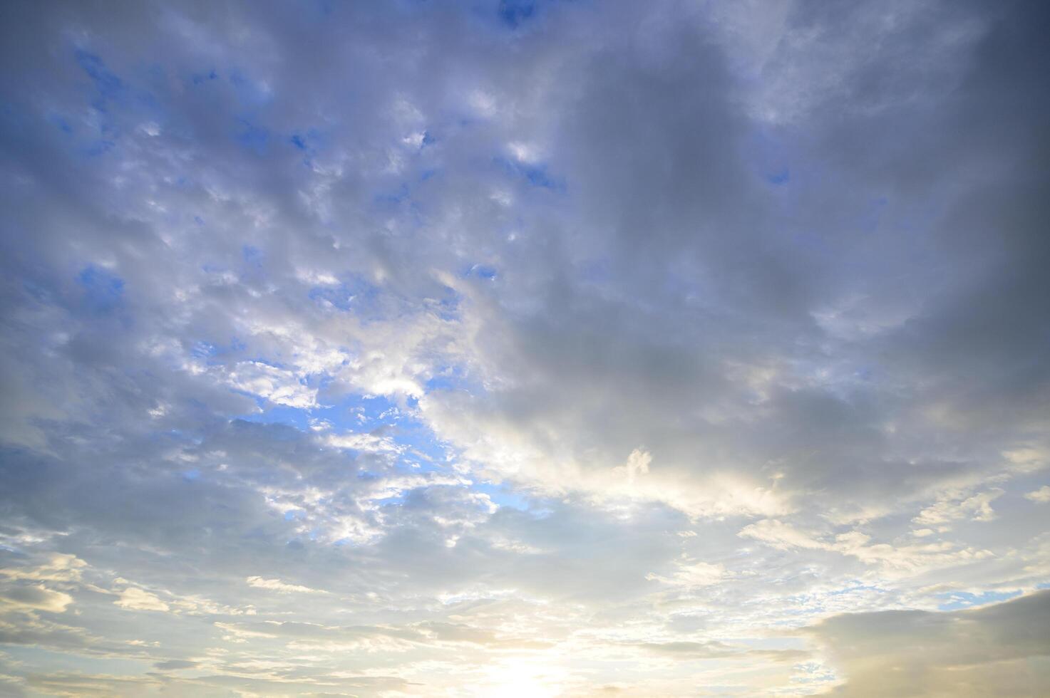 Clouds in a blue sky at golden hour photo