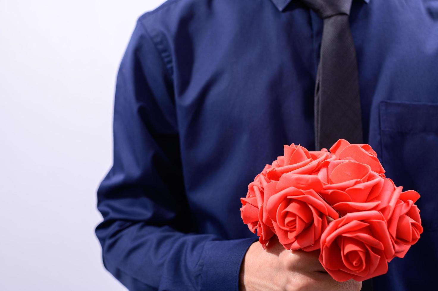 Man holding red flowers photo