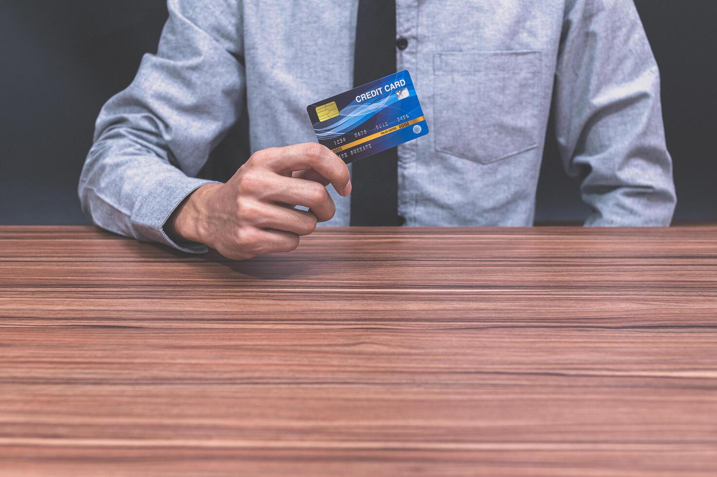 Person holding credit card photo