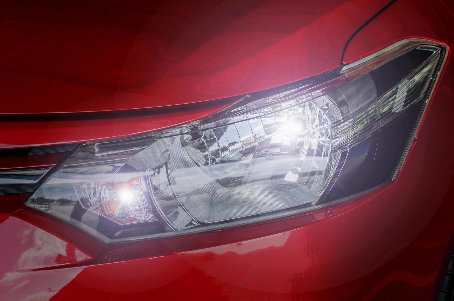 Headlight on a red car photo