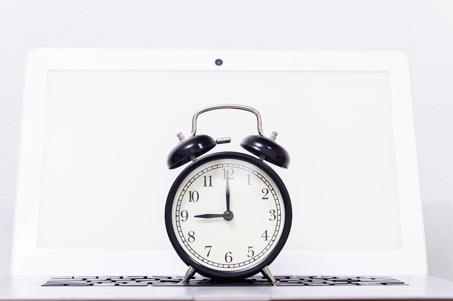 Alarm clock on laptop 1917446 Stock Photo at Vecteezy
