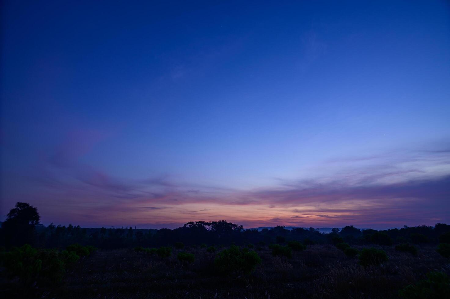 Silhouette of land at sunset photo