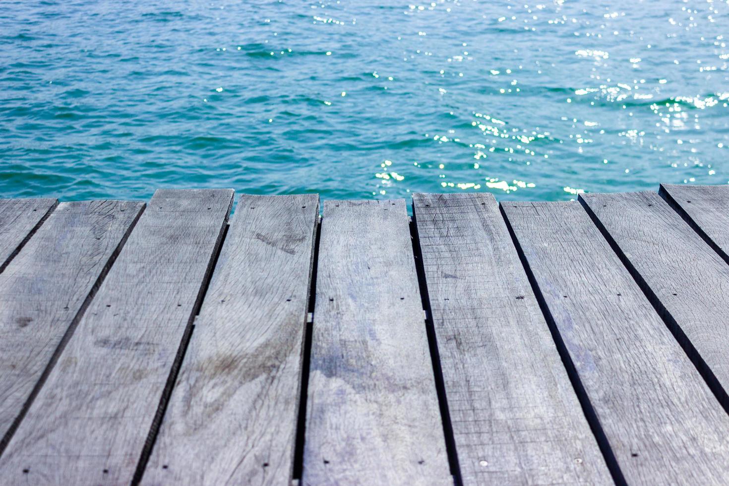 Wood tabletop for display with blue water for background photo