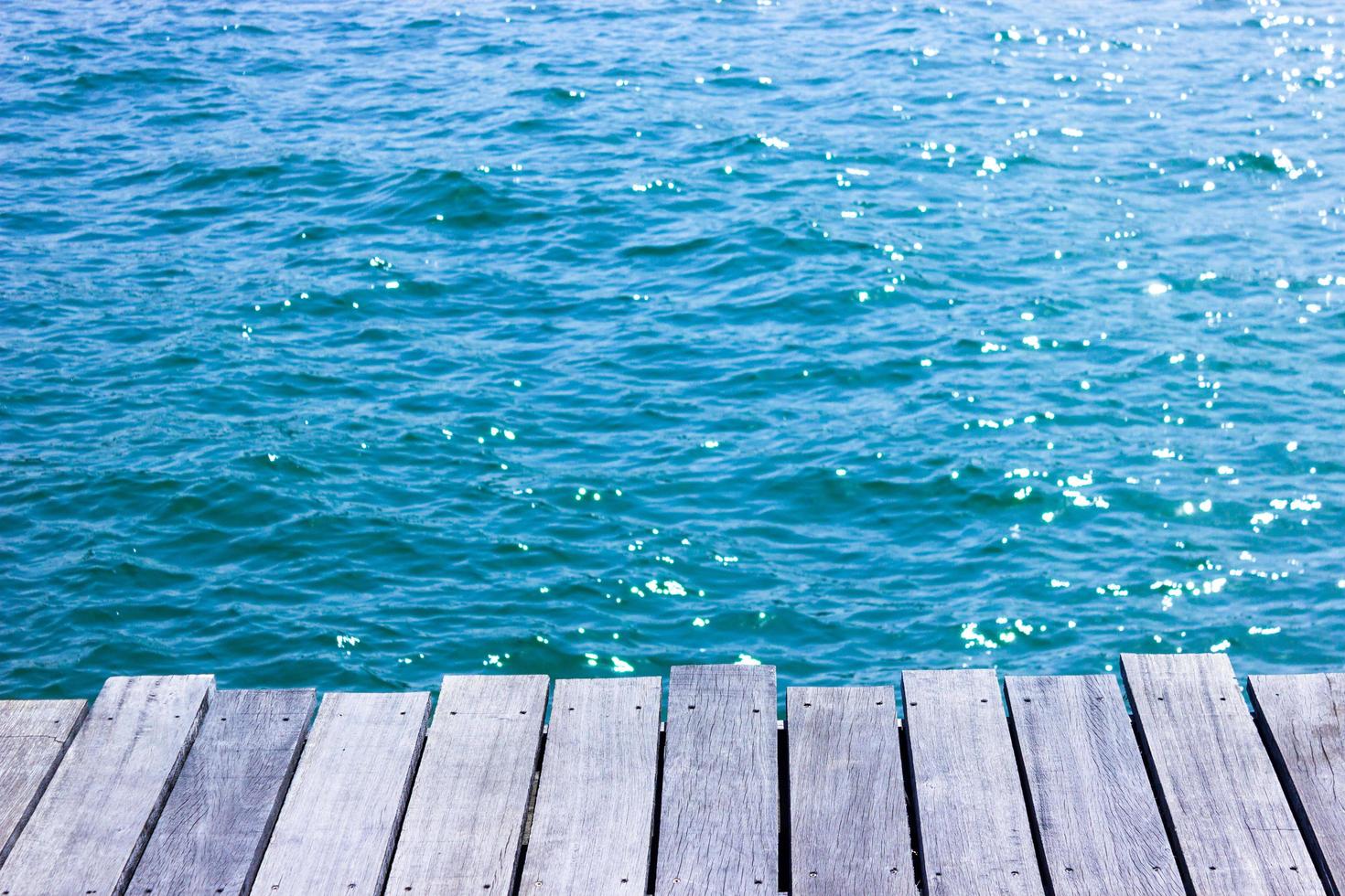 Wood tabletop for display with blue water for background photo