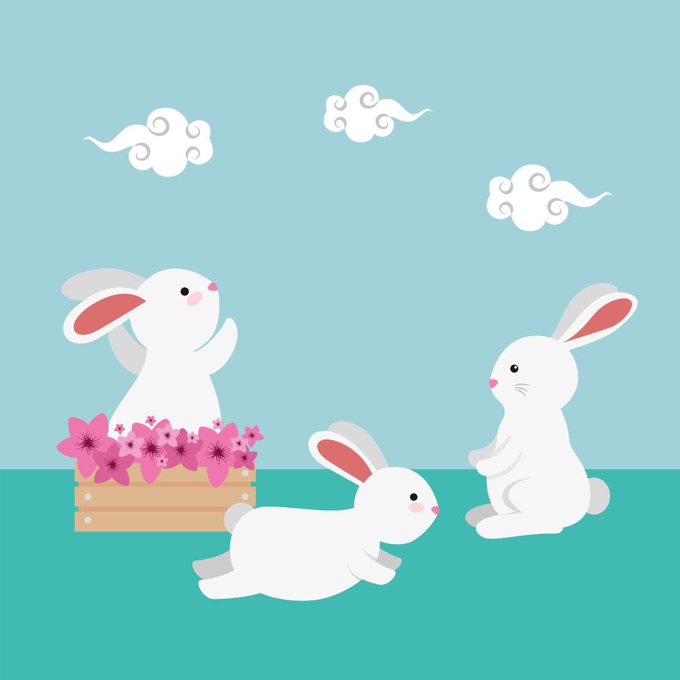 lindo y pequeño grupo de conejos con caja de madera floral vector