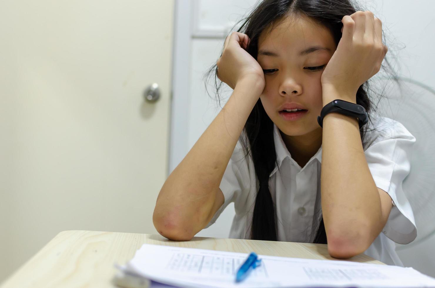 School girl struggling with homework photo