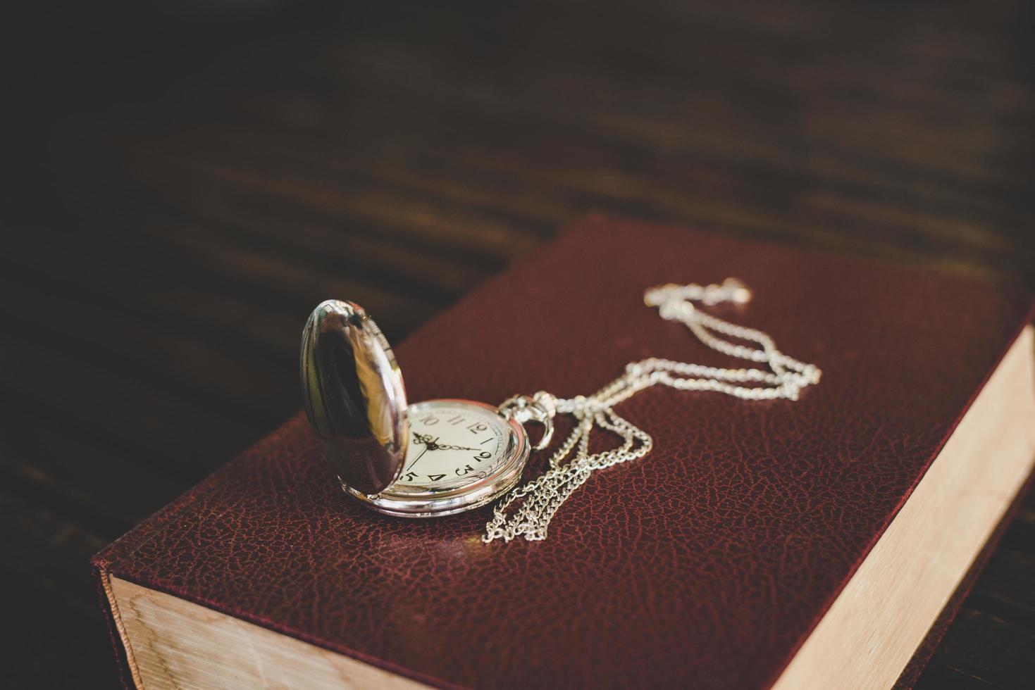 Close up of a vintage pocket watch on old books photo