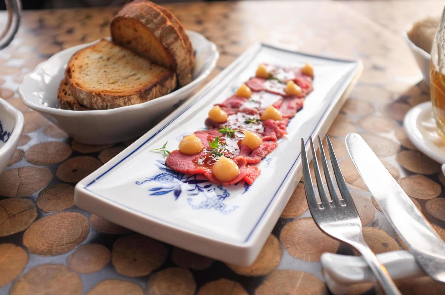 Beef sashimi with bread photo