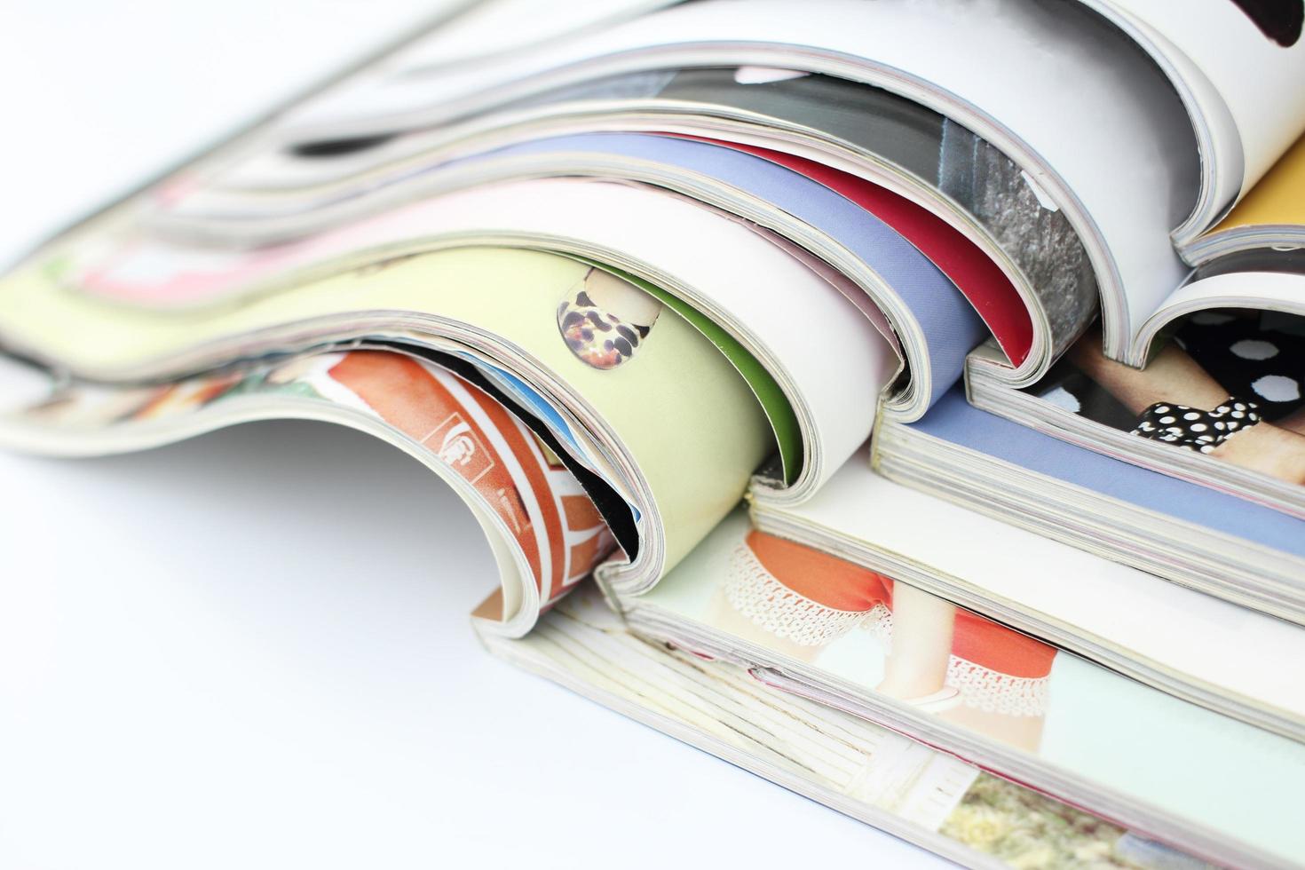 Stack of magazines on white background photo