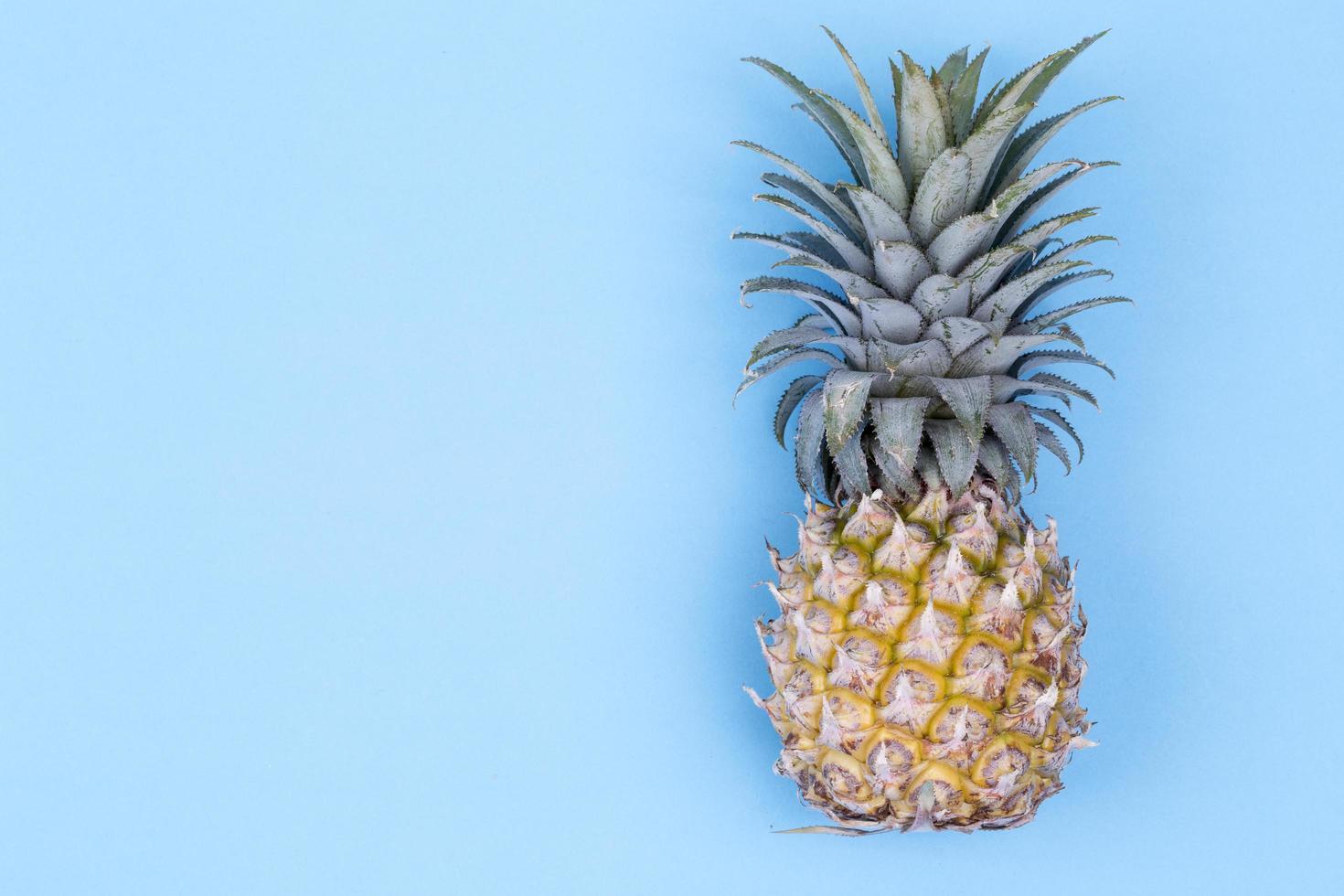 Pineapple on blue background photo