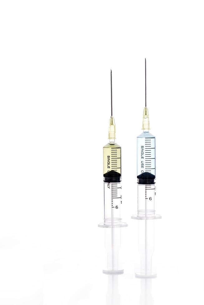 Two syringes on white background photo