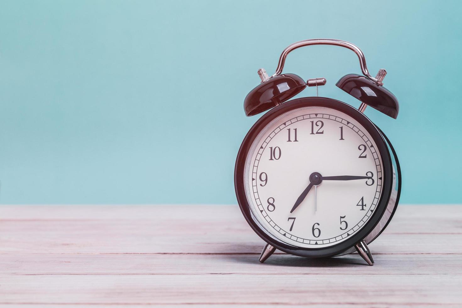 Alarm clock on wooden table photo