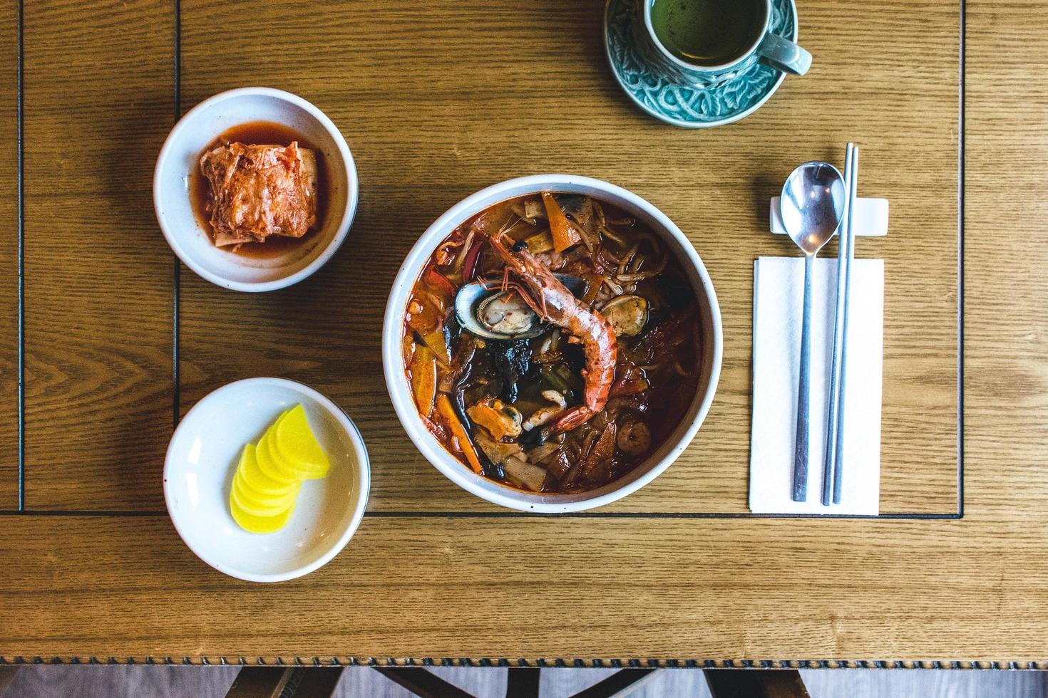 Top view of Korean spicy seafood soup with king prawns photo