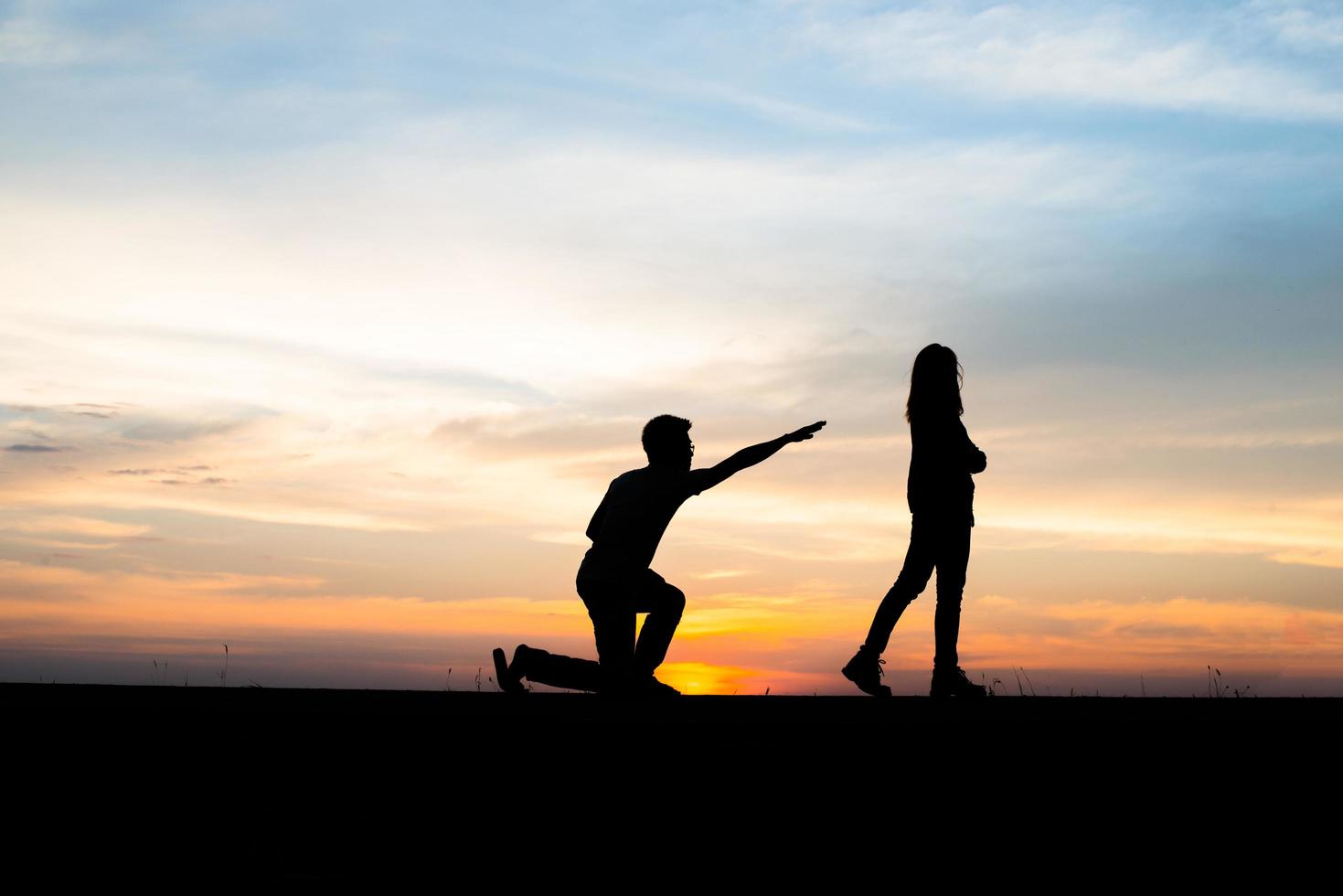 Silhouette of an upset couple in a quarrel at sunset photo