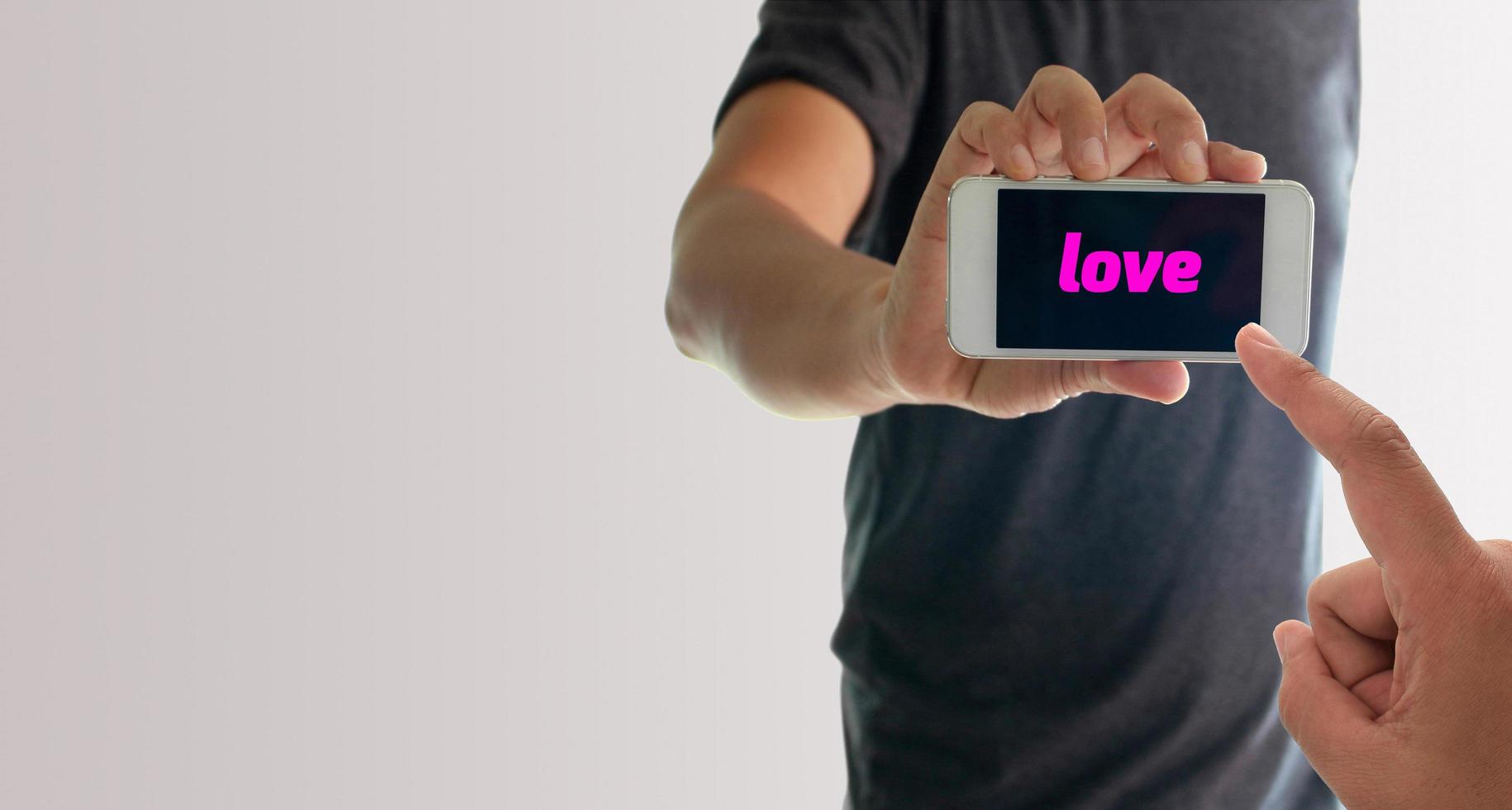 hombre sujetando el teléfono con amor en la pantalla foto