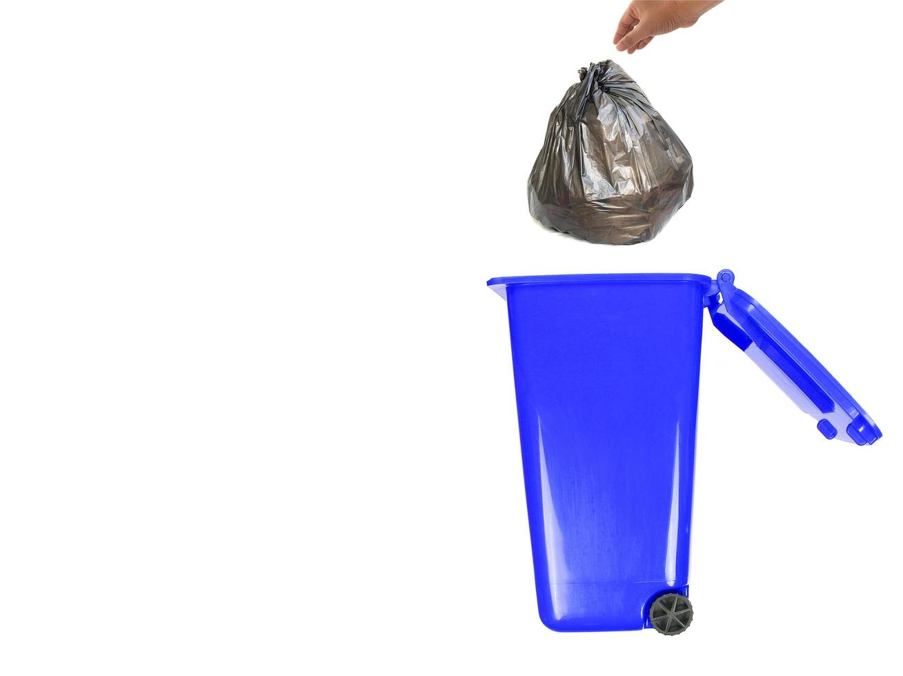 Blue trash can with trash bag photo