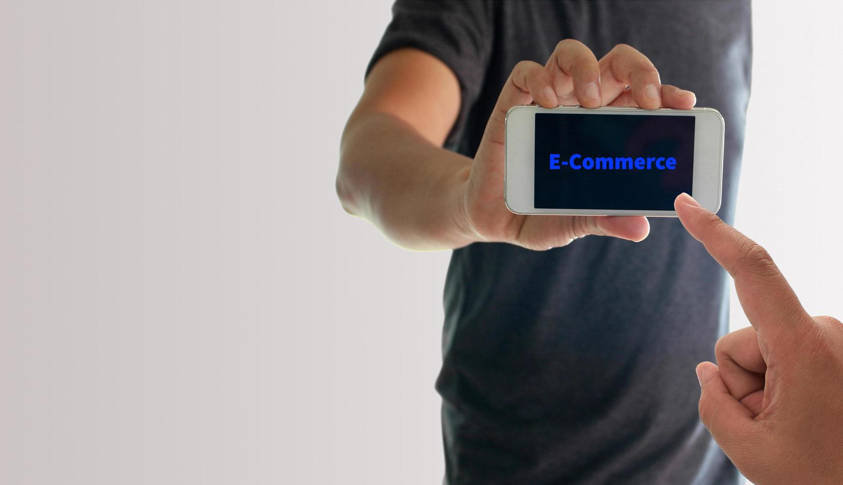 Person holding phone with e-commerce on screen photo