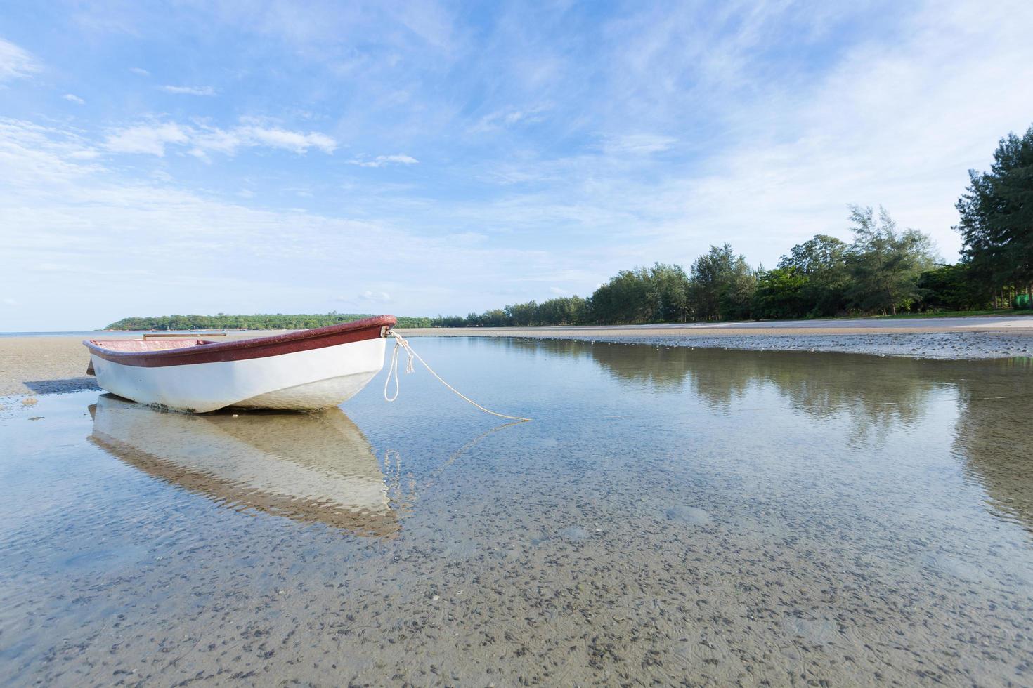 Small boat on the beach photo