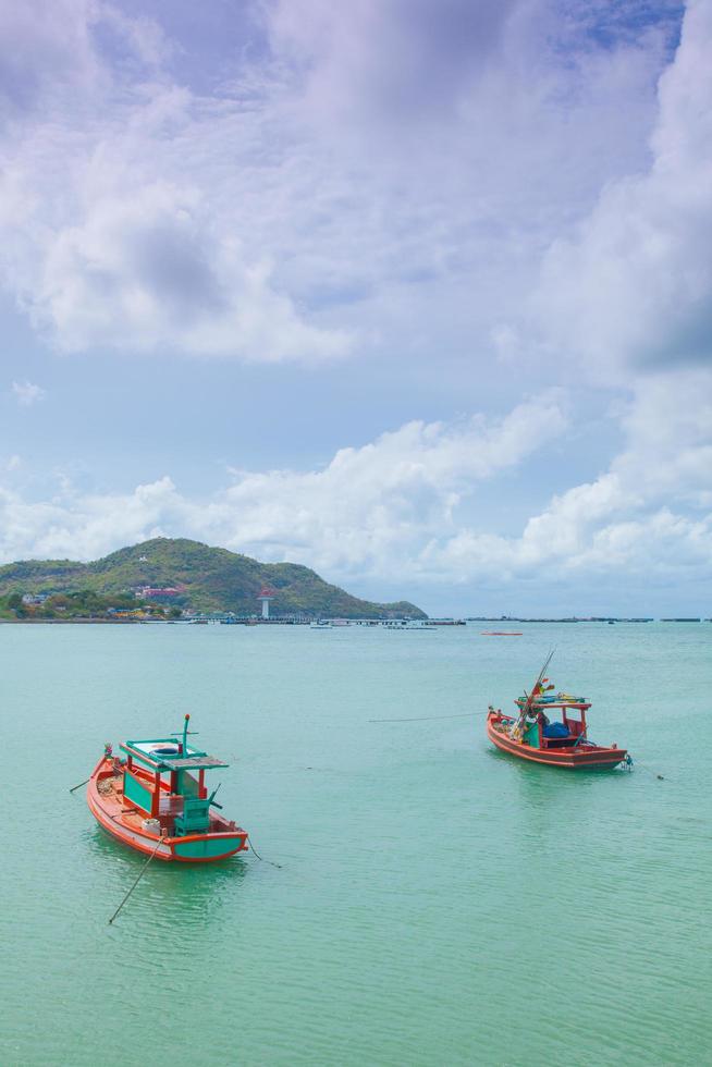 Small fishing boats moored in the sea photo