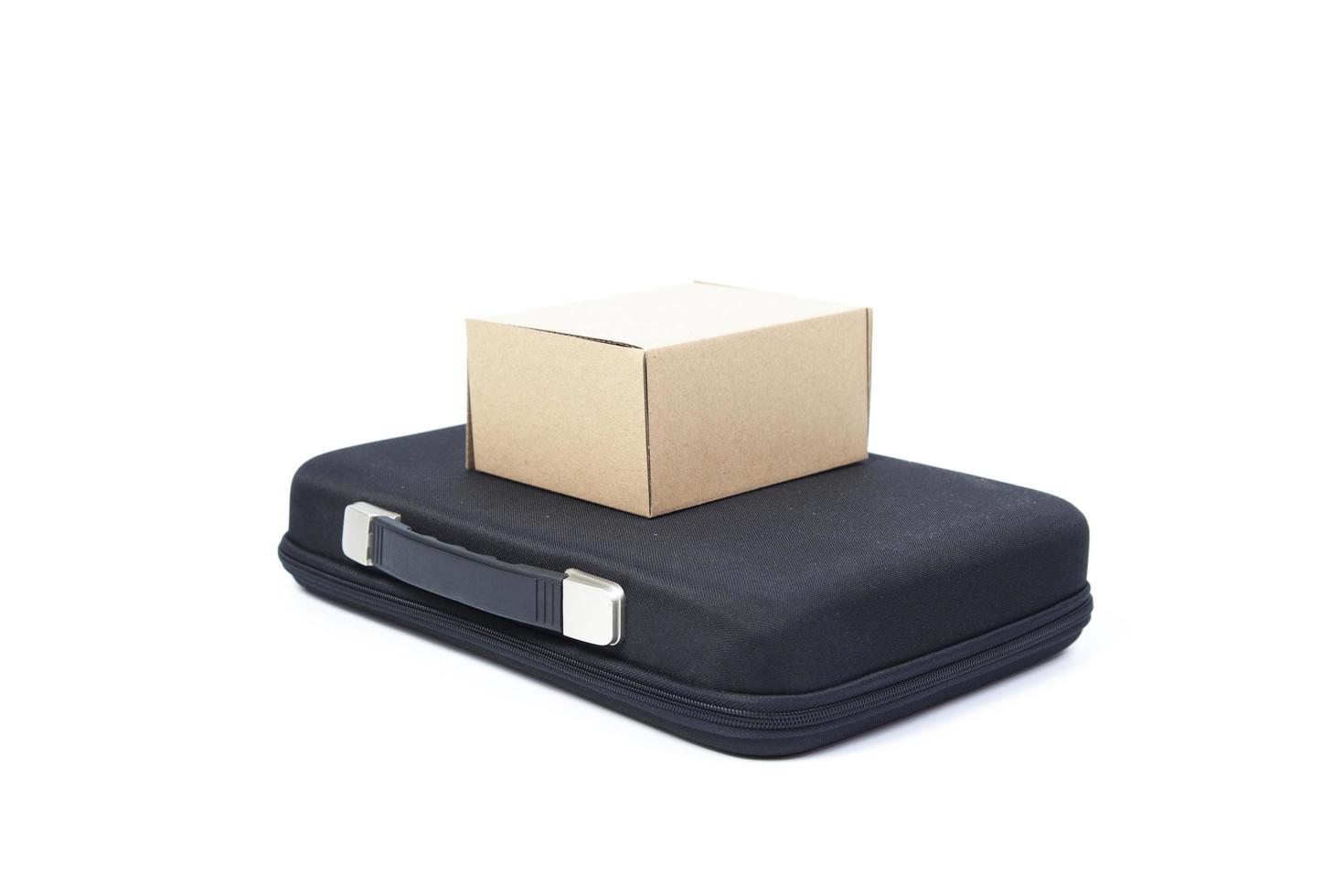 Brown paper box on a black briefcase photo
