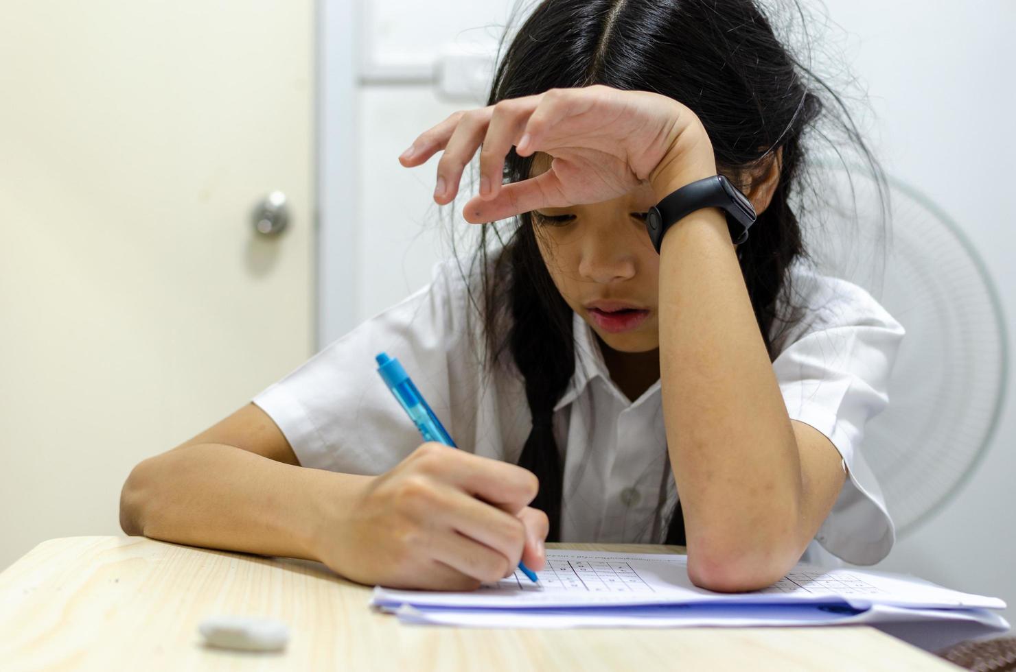 School girl doing homework photo