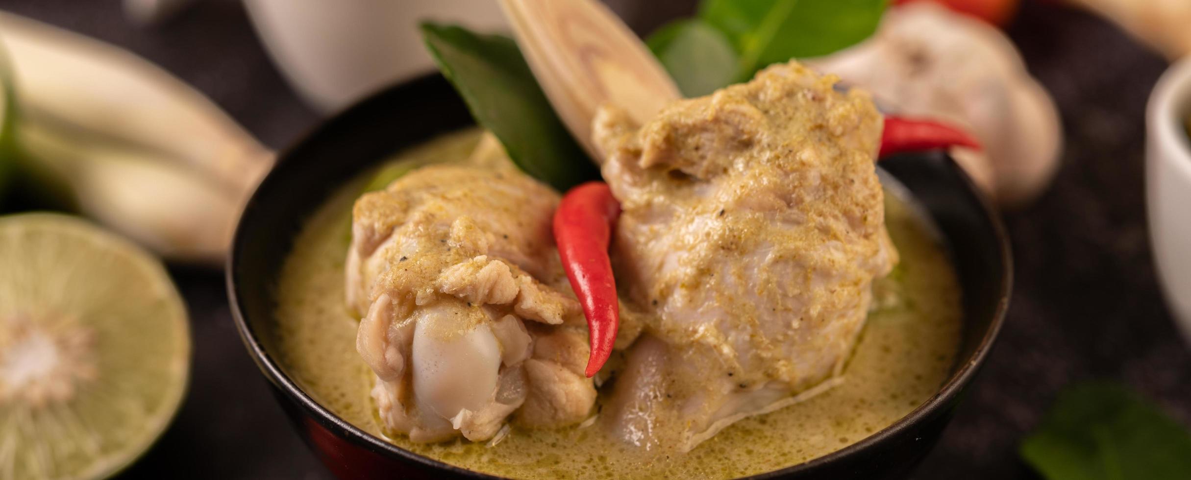 Green curry dish with chicken, chili and basil and tomato and lime photo