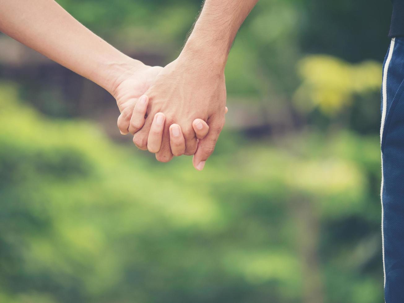 Image of a couple holding hands together photo