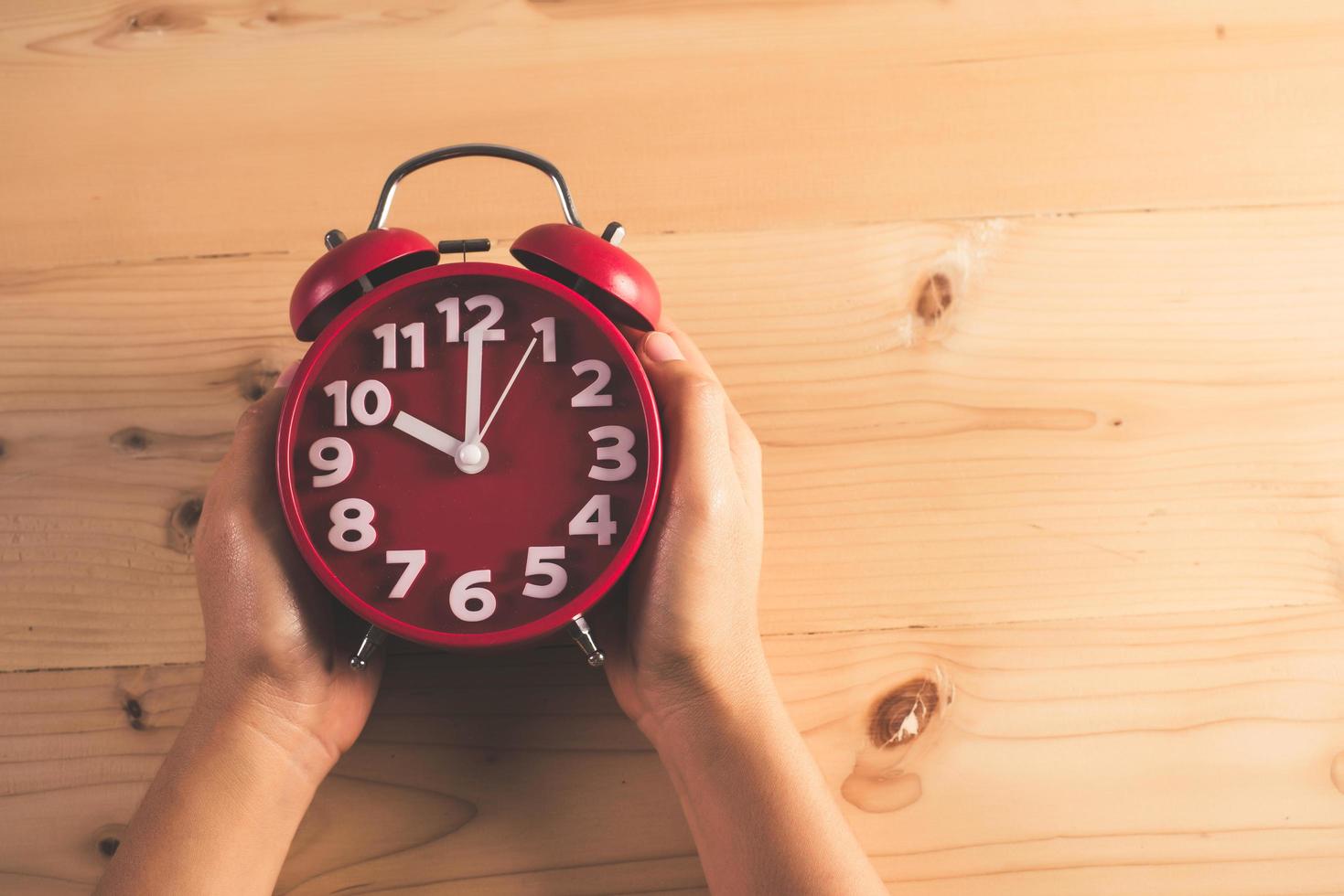 Hand with red alarm clock photo