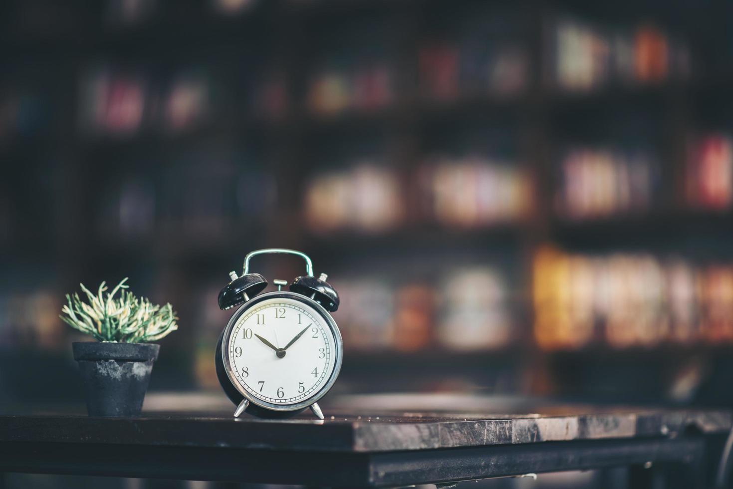 Retro alarm clock on a wooden table photo