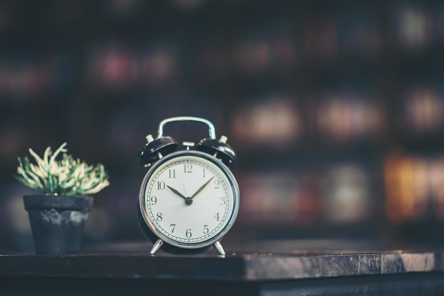 Retro alarm clock on a wooden table photo