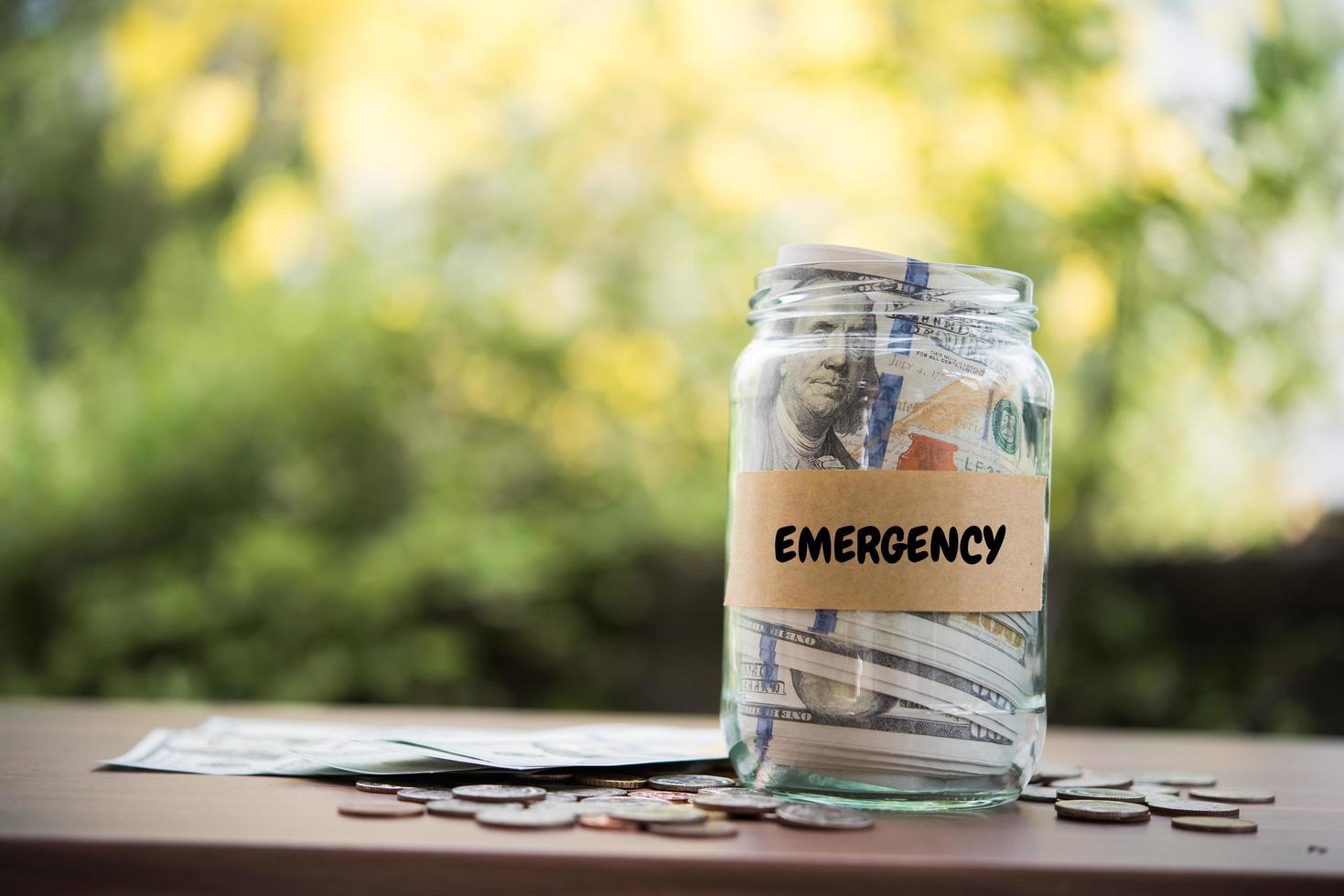 Money in a glass jar in nature, investment concept photo