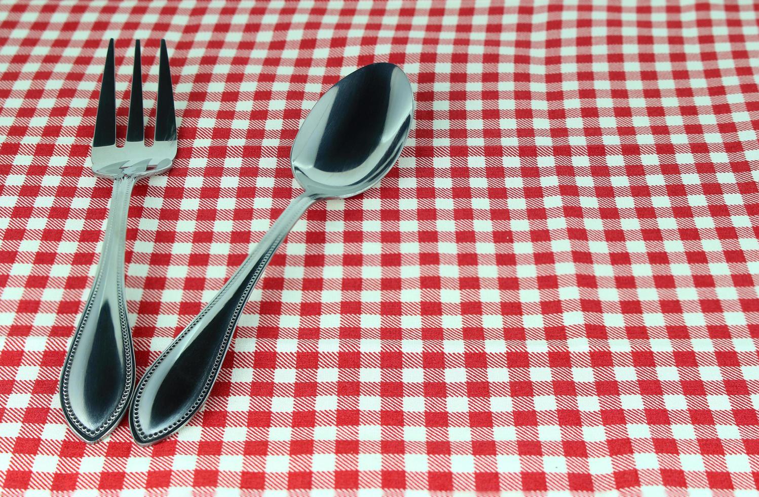 Silverware on red cloth photo