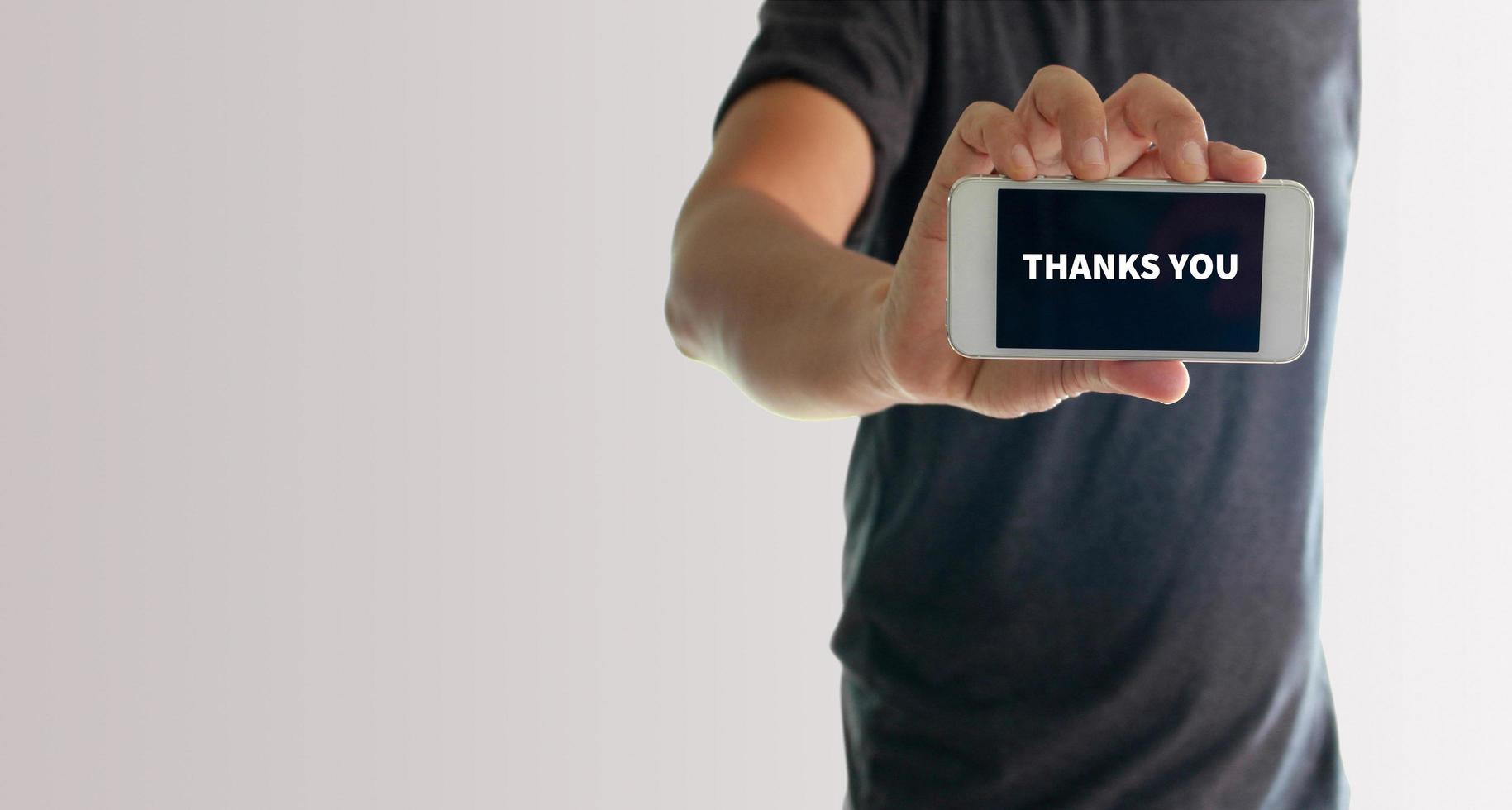 Man showing phone with thank you on screen photo