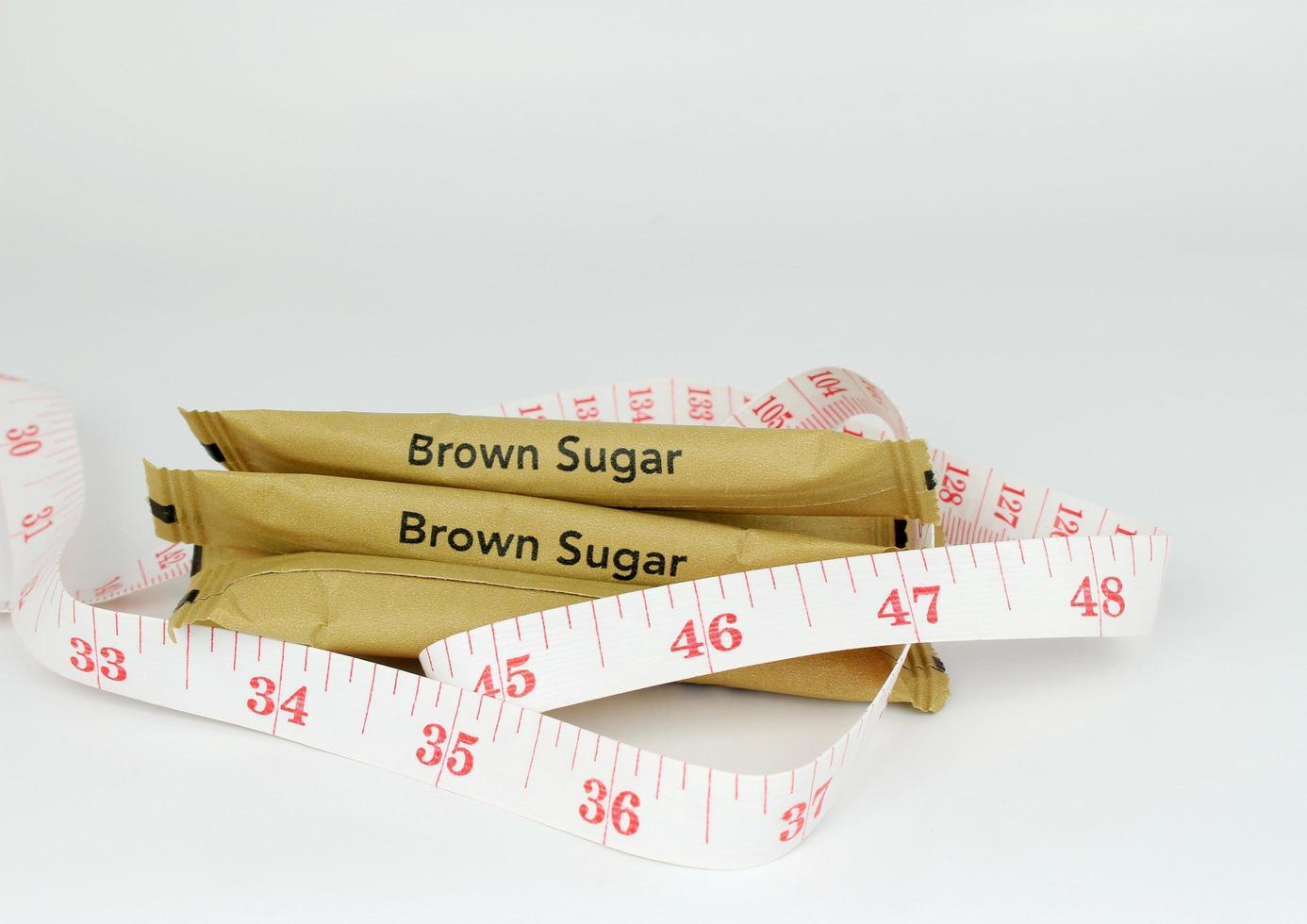Sugar packets and measuring tape photo