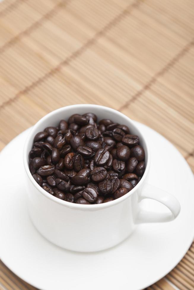 Roasted coffee beans in a cup photo